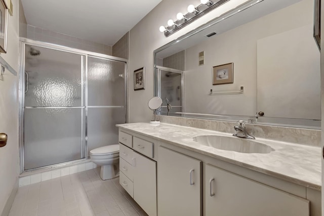 bathroom featuring vanity, walk in shower, and toilet