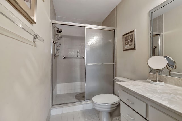 bathroom featuring vanity, an enclosed shower, and toilet