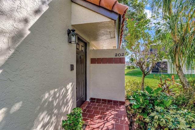 doorway to property with a yard