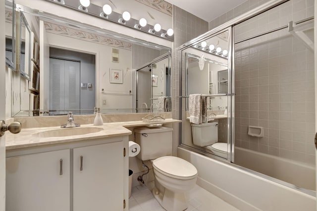 full bathroom featuring enclosed tub / shower combo, vanity, toilet, and tile patterned floors