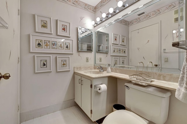 bathroom with tile patterned floors, vanity, and toilet