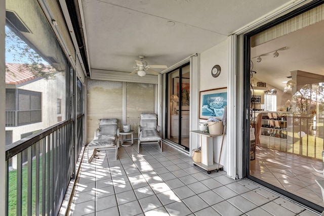 unfurnished sunroom with plenty of natural light, lofted ceiling, and ceiling fan