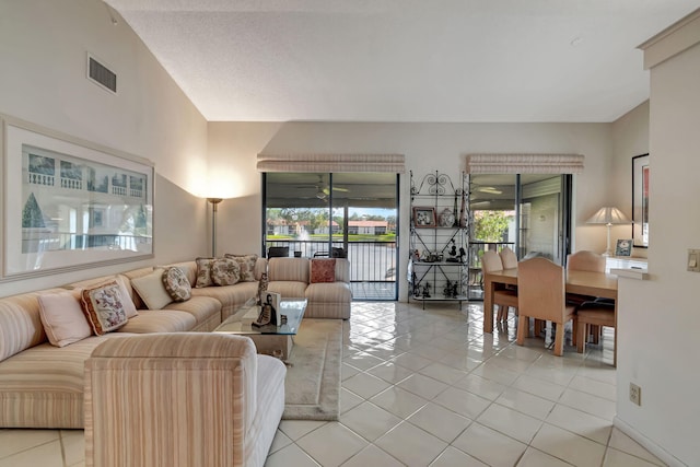 tiled living room featuring ceiling fan