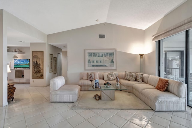 tiled living room featuring lofted ceiling