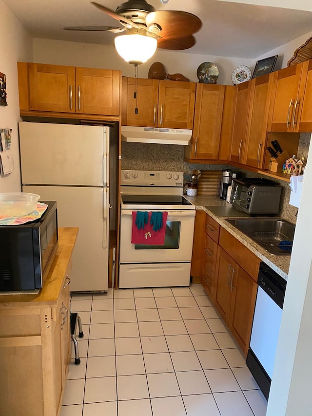 kitchen with light tile patterned flooring, ceiling fan, white appliances, and sink