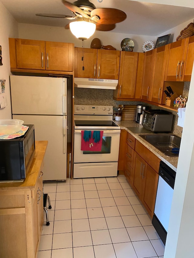 kitchen featuring ceiling fan, white appliances, sink, backsplash, and light tile patterned floors