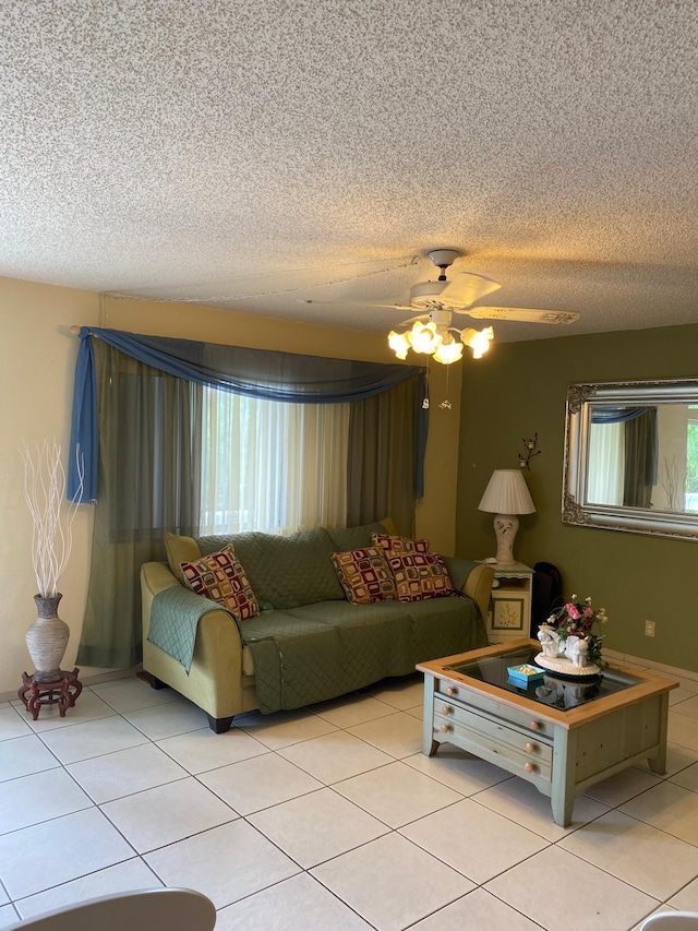 unfurnished living room with ceiling fan, light tile patterned floors, and a textured ceiling