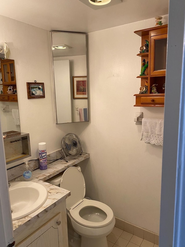 bathroom featuring vanity, tile patterned flooring, and toilet