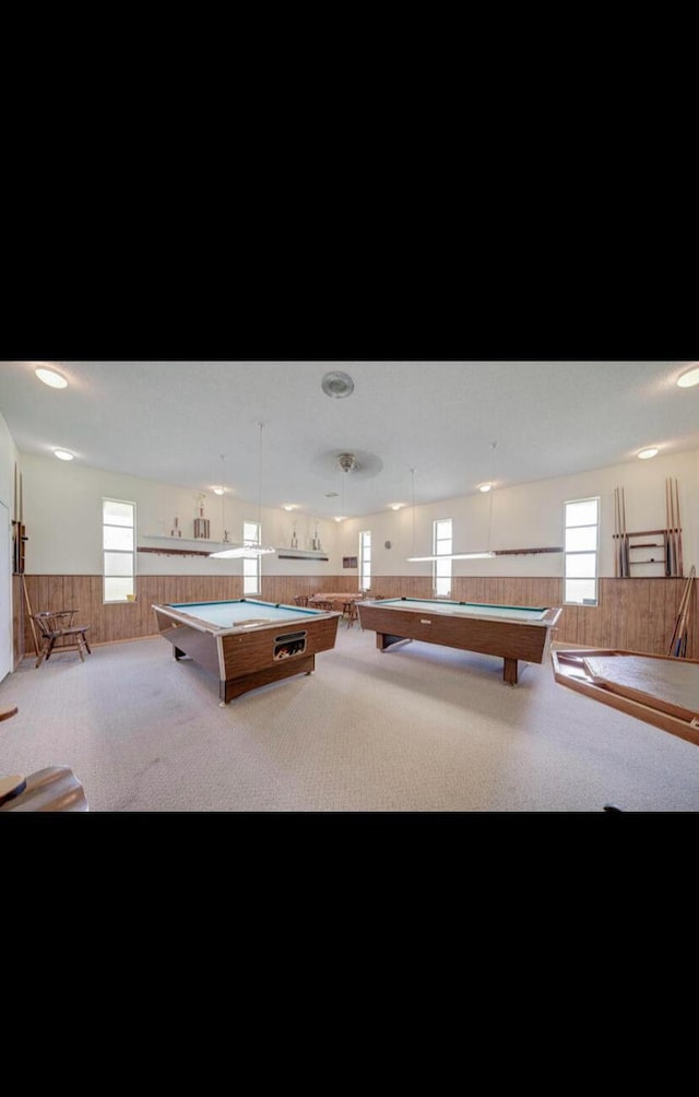 playroom featuring light carpet, wooden walls, and billiards