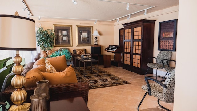 living area with french doors, rail lighting, and light tile patterned flooring