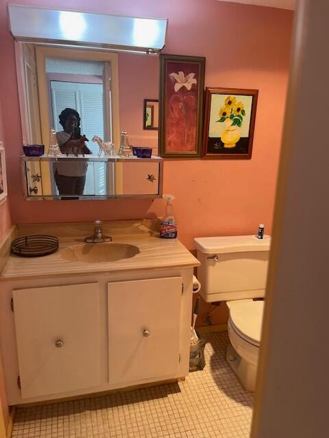 bathroom with vanity, toilet, and tile patterned flooring