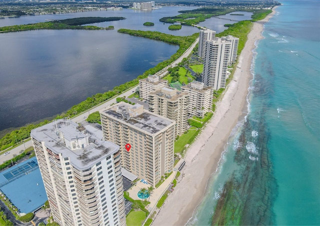 bird's eye view featuring a water view and a beach view