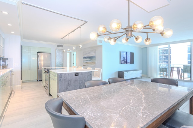 dining room with rail lighting, light hardwood / wood-style floors, and ornamental molding