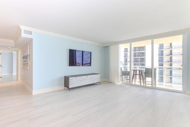 unfurnished living room featuring ornamental molding and light hardwood / wood-style flooring