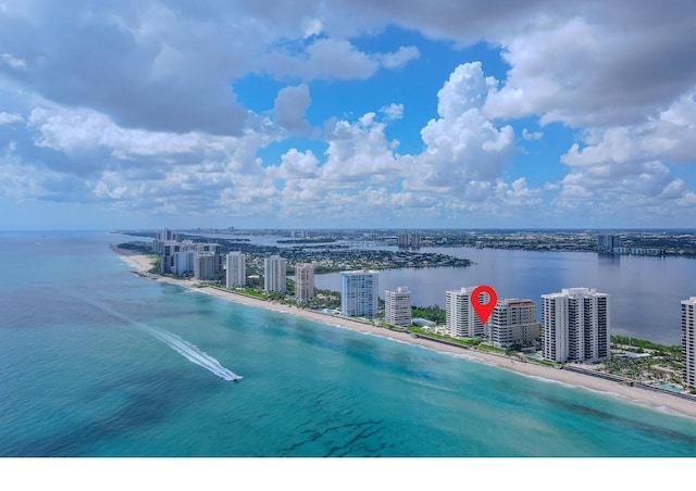 bird's eye view with a water view and a beach view