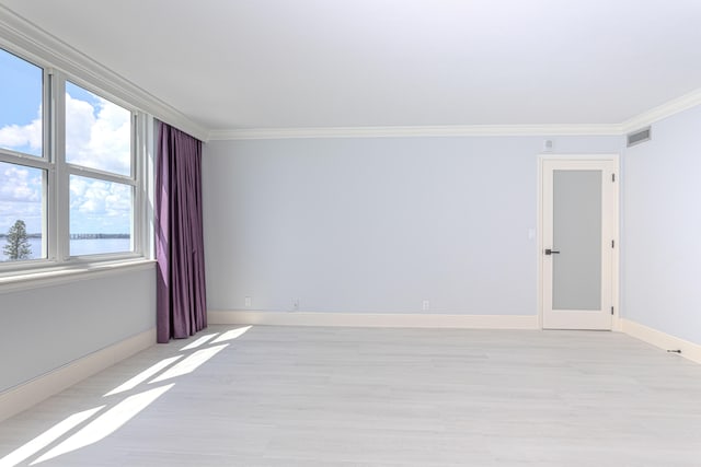 empty room featuring crown molding and light hardwood / wood-style flooring