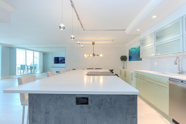 kitchen featuring a center island, a breakfast bar area, hanging light fixtures, ornamental molding, and stainless steel dishwasher