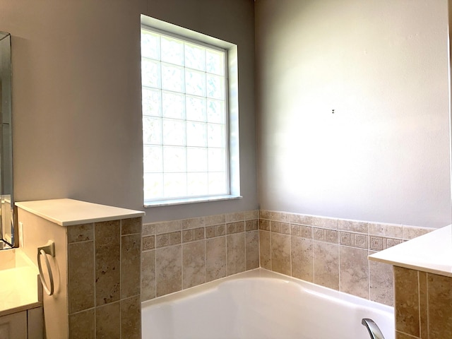 bathroom featuring vanity and a tub