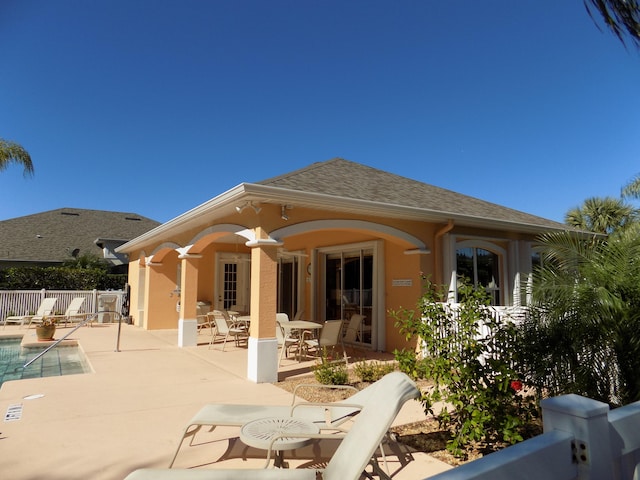 back of house featuring a patio area and a fenced in pool