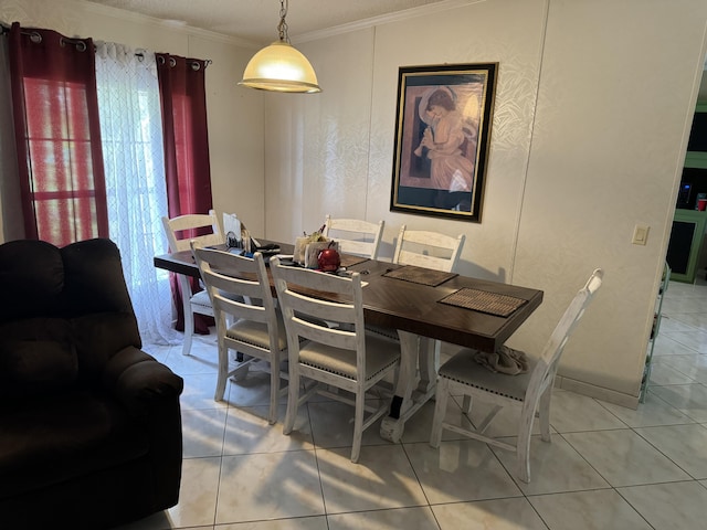 tiled dining space featuring ornamental molding