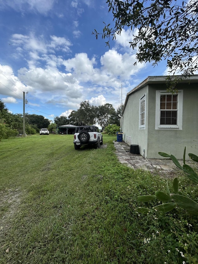 view of yard with a rural view and a deck