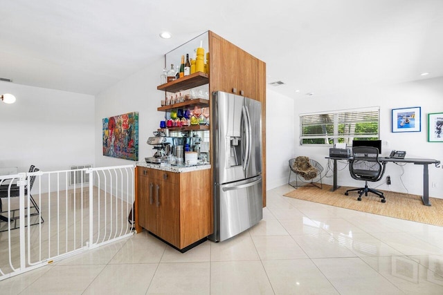 kitchen with stainless steel refrigerator with ice dispenser and light tile patterned floors