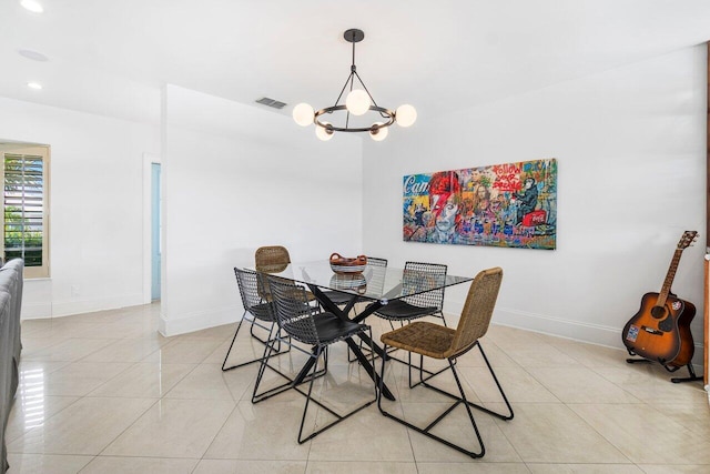 dining space featuring light tile patterned floors and an inviting chandelier