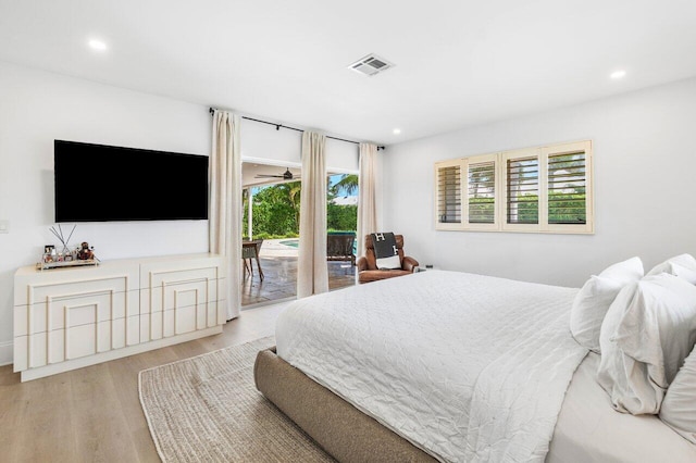 bedroom featuring access to exterior and light wood-type flooring