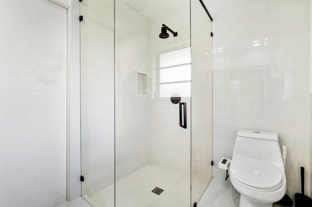 bathroom with toilet and a shower with shower door