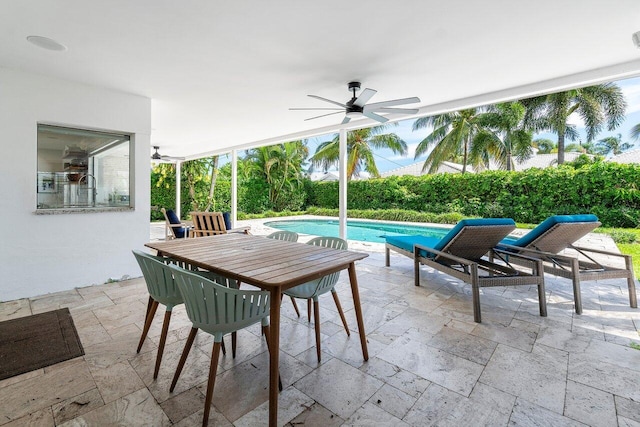 view of patio featuring ceiling fan and a fenced in pool