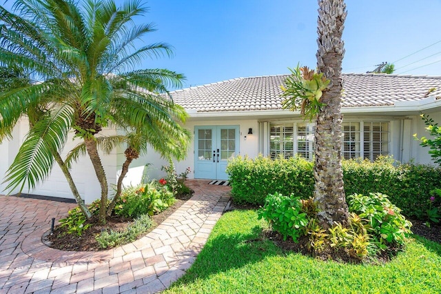 view of front of house featuring a garage and french doors