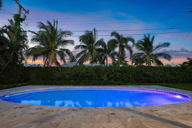 view of pool at dusk