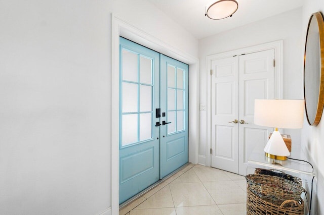 entryway featuring light tile patterned floors, french doors, and plenty of natural light