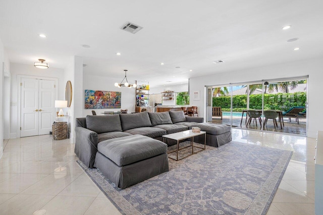 tiled living room with an inviting chandelier