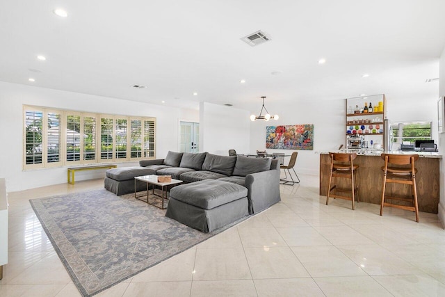 tiled living room with a chandelier