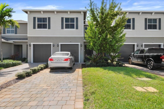 view of front of property with a front yard and a garage