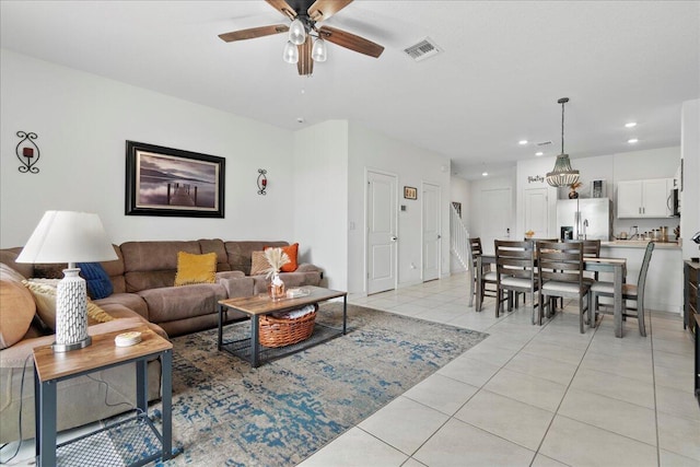 living room featuring light tile patterned floors and ceiling fan