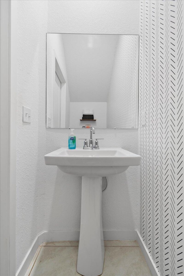 bathroom featuring sink and vaulted ceiling