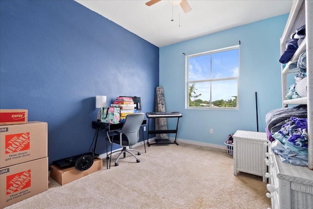 carpeted home office featuring ceiling fan