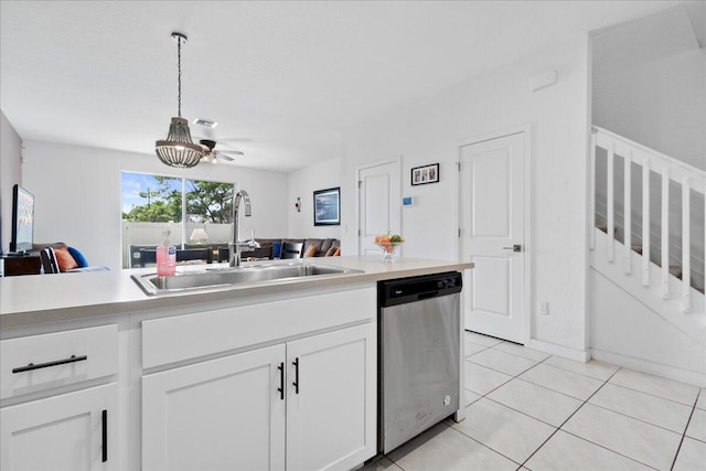 kitchen with light tile patterned floors, white cabinetry, stainless steel dishwasher, pendant lighting, and sink