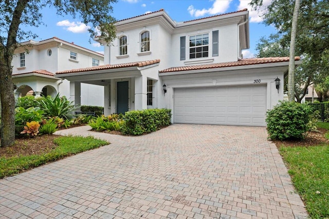 mediterranean / spanish house with a garage