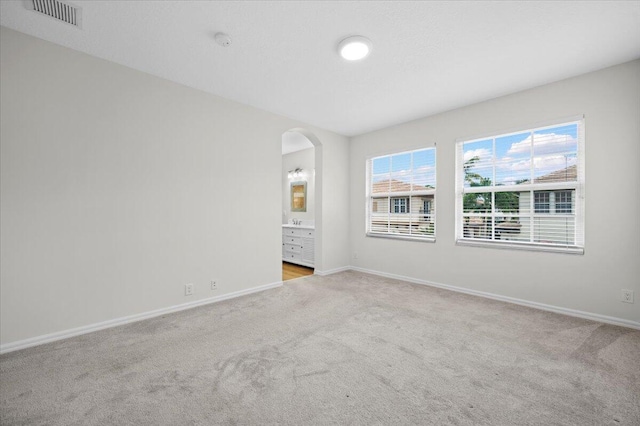 empty room featuring light carpet