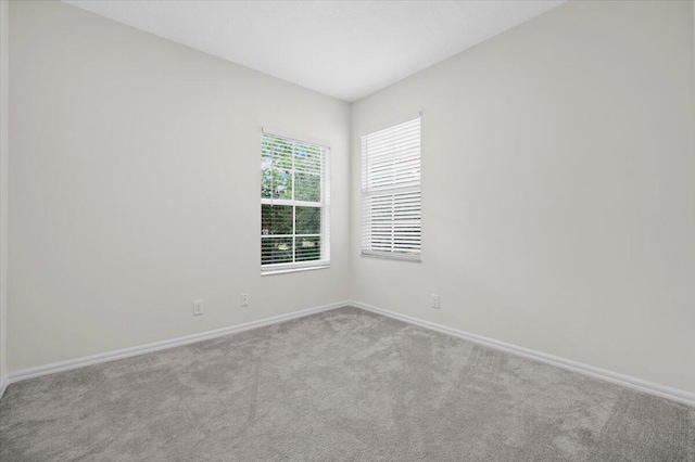 unfurnished room with light colored carpet