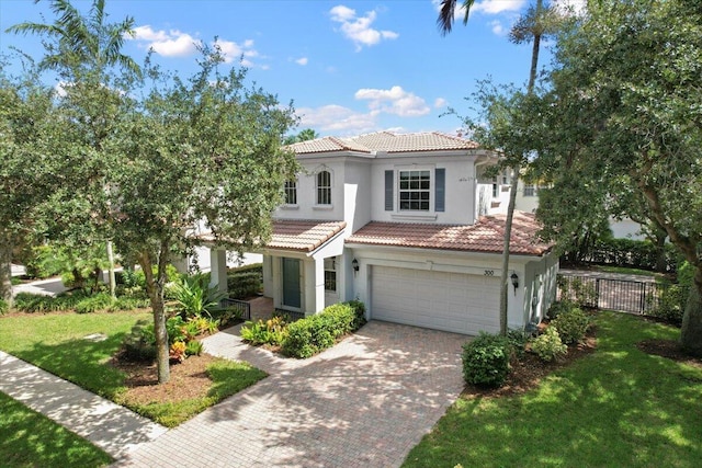 mediterranean / spanish-style home with a garage and a front yard