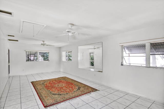 spare room with ceiling fan and light tile patterned flooring