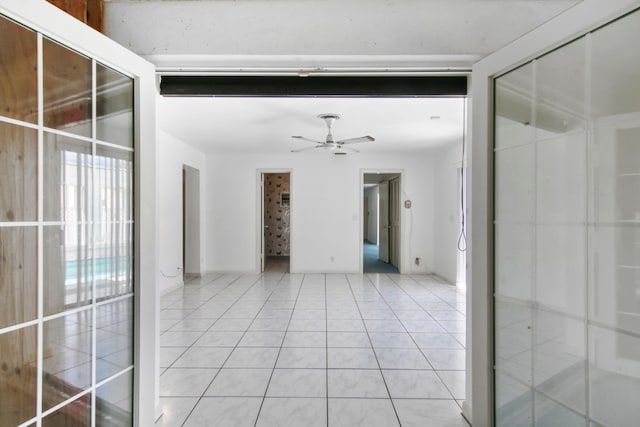 empty room featuring light tile patterned floors and ceiling fan