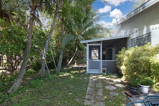 view of yard featuring a sunroom