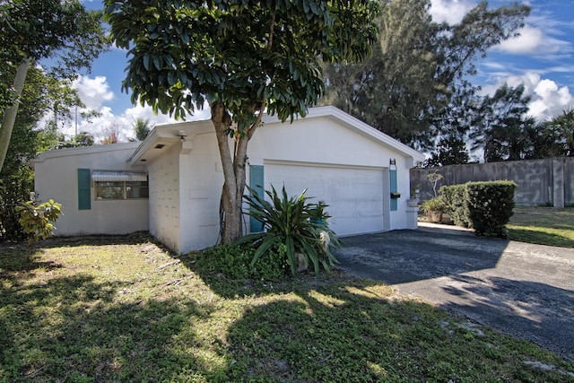 view of home's exterior featuring a garage and a lawn