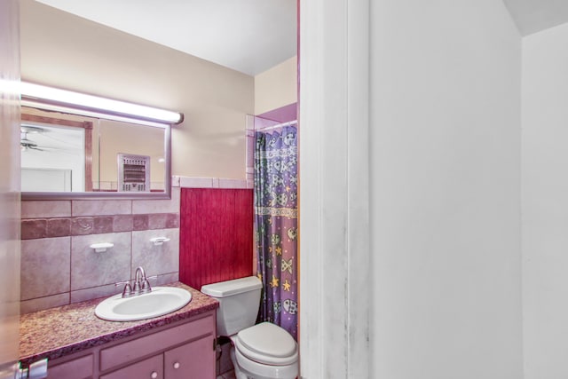 bathroom featuring vanity, toilet, and a shower with shower curtain