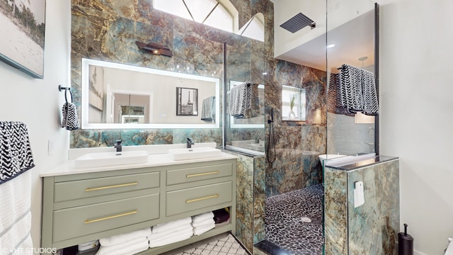 bathroom featuring vanity, tile walls, tile patterned flooring, and a tile shower